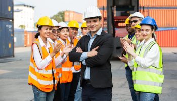 Group of construction worker or engineer applauding to manager for success work. Logistics teamwork and support for company. warehouse business and factory